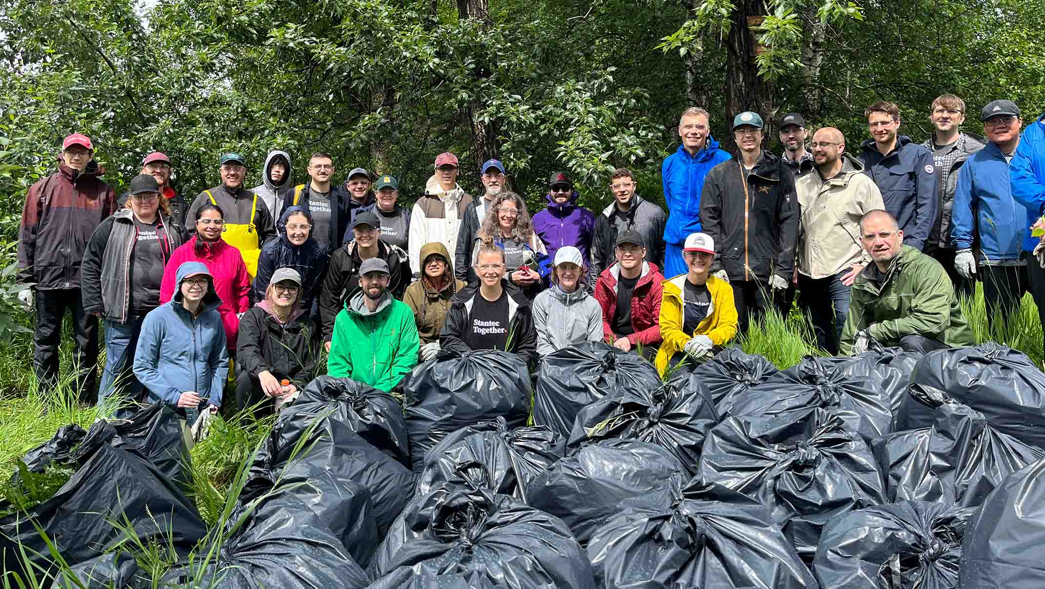 Group of people with full garbage bags