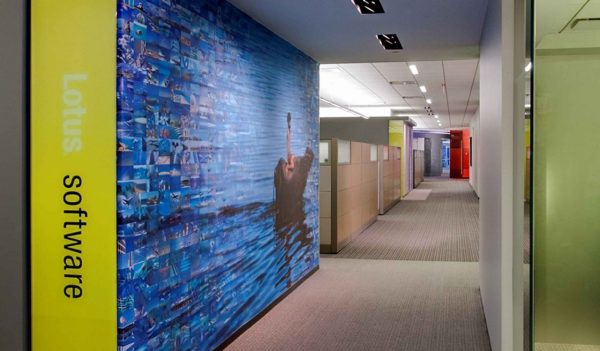 Wall graphics utilize employee photography to provide the staff with a sense of ownership in their workplace.