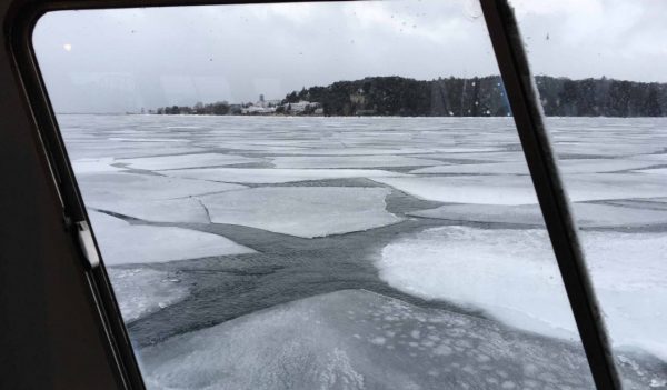 Looking out of a ferry window at large chunks of cracked ice.