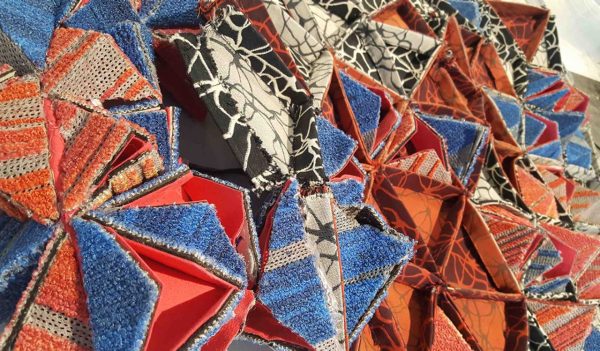 Close up shot of geometric carpet samples assembled to create a dress.