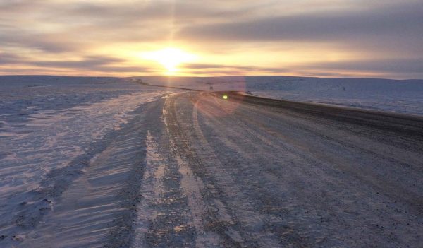 snowy road, bright sun