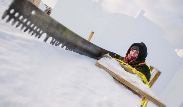 Leslie Merrithew saws a snow block