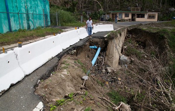 Naguabo, Puerto Rico - Carlos Murati, Public Assistance staff, assess extensive road damage