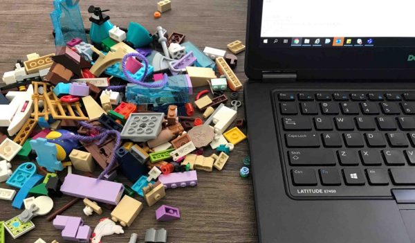 Lego and toys on desk with laptop