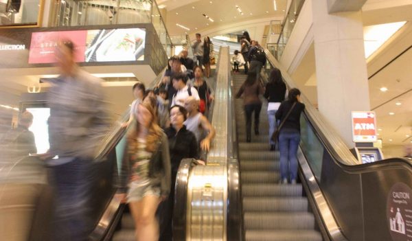 People on escalator in shopping mall