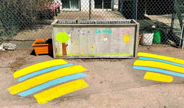 Planters box in a back alley decorated with sidewalk chalk