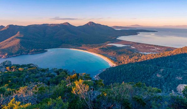 Sunrise nature landscape of beautiful ocean bay, lagoon and mountains. Wineglass bay in Tasmania, Australia