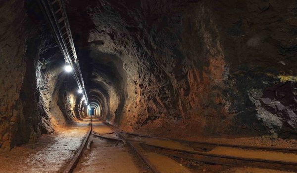 Underground mine passage with rails and light
