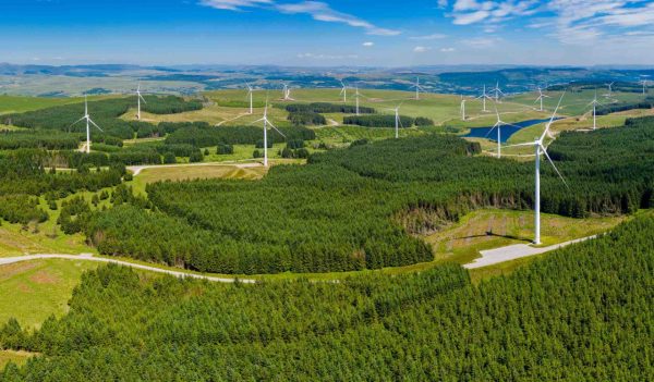 Aerial drone panorama of turbines at a large onshore windfarm in Wales, UK