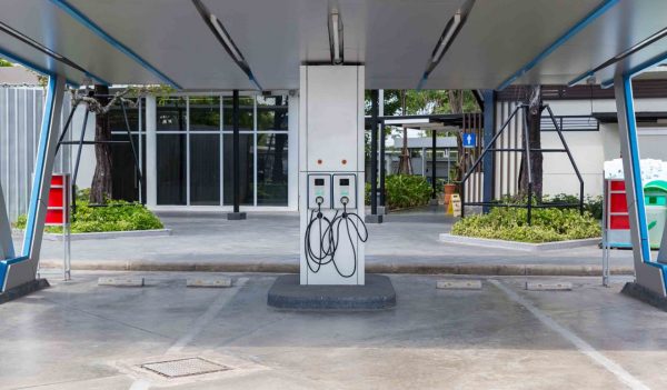 Hybrid car Electric charger station in the Car Park. Electric car charging on parking and charging station.