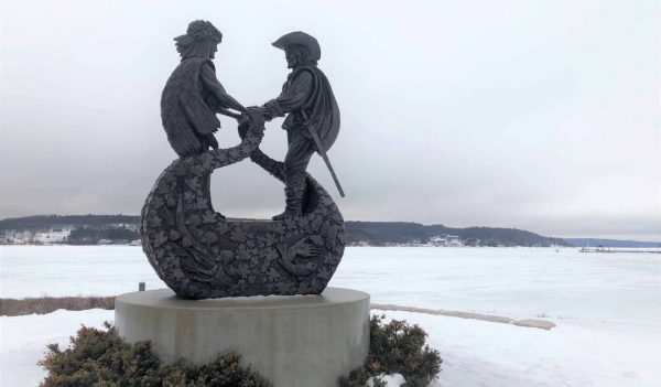 A statue by the waterfront in Penetanguishene, Ontario, that shows the meeting of France’s Samuel de Champlain and Chief Aenons of the Wendat Bear Tribe in 1615.