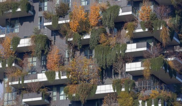 Modern residential tower in Milan with landscaping on the balconies creating a green wall.