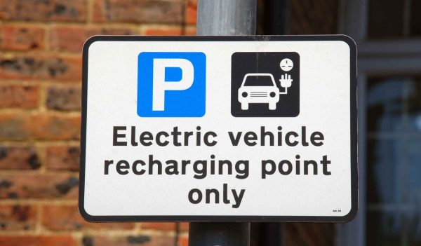 An electric vehicle charging point sign in a car park at Tenterden in Kent, England