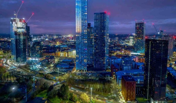 Deansgate Square Manchester England, construction building work at dawn with city lights and dark skies of this Northern English city. 