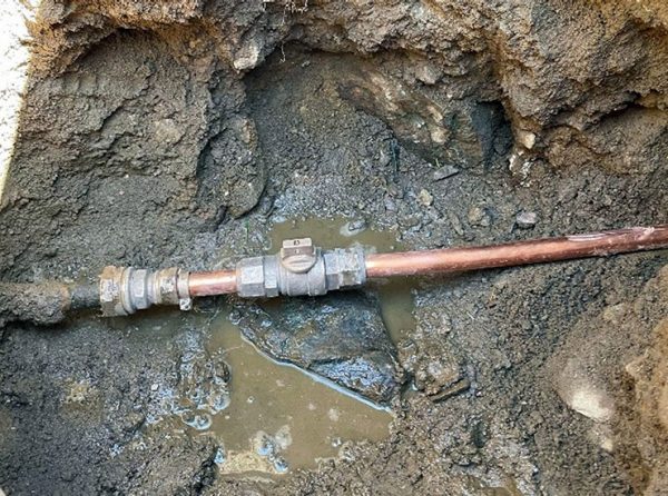 Underground lead utility pipe exposed.