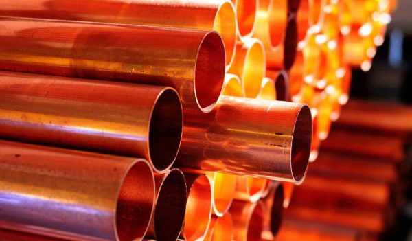Close-up of stacked copper pipes.