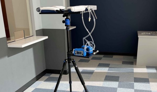 Air quality monitoring tools on a tripod monitoring the air quality in an office.