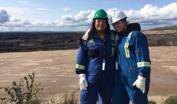 Two OYEP participants pose for a picture while overlooking the Kearl open pit oilsands mine.