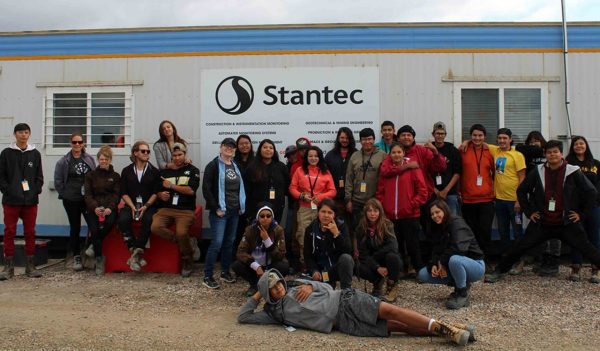 The OYEP group and Stantec Operations Support Team pose in front of the on-site field office at the Imperial Kearl Oilsands Mine.