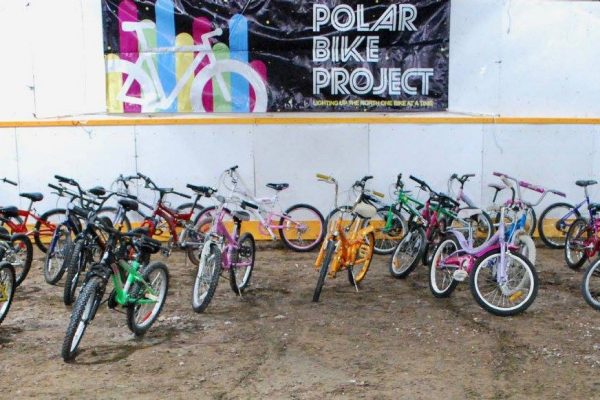 Bikes parked in front of the Polar Bike Project banner