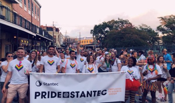 A group of people with a Pride@Stantec banner