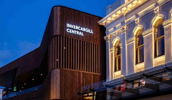 Close up of the upper building detail - wood vertical slats against a night sky.