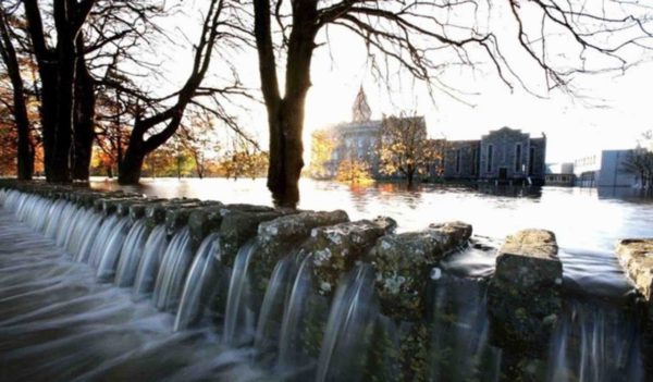 Small waterfall with St. Flannan's College in the background.