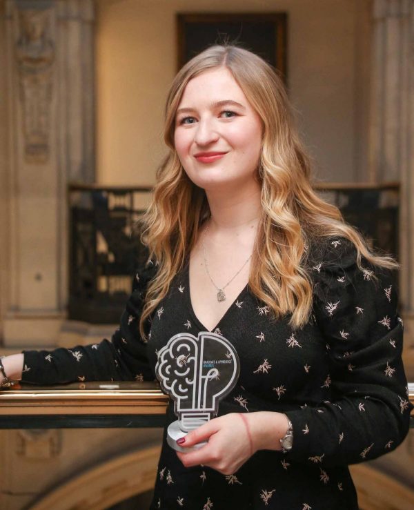 Photograph of Lucy Ashen holding her Graduate of the Year Award trophy at the New Civil Engineer (NCE) Graduate & Apprentice Awards