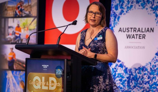 Natalie Muir speaking at a podium