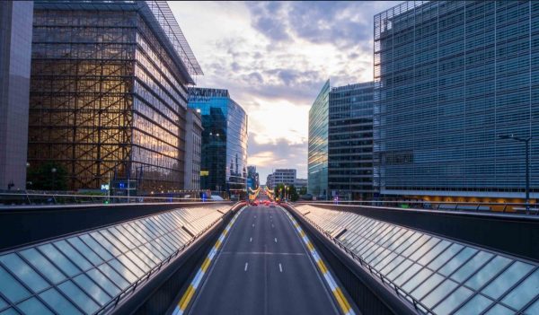 Long exposure shot from a bridge in Brussels. Traffic tunel and Europen headquarters in the foreground
