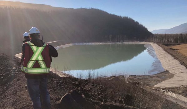 Environmental Engineers surveying a mine tailings pond