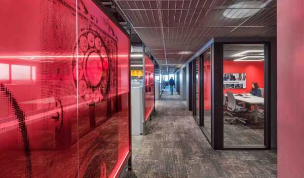 Hallway between offices with a red graphic wall on the left