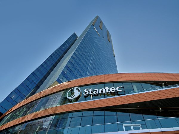 A view looking up at the tower with Stantec signage