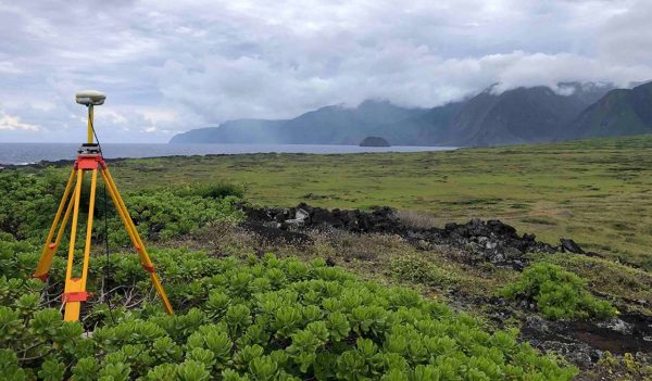 Surveying equipment in a remote area near the ocean in Hawaii.