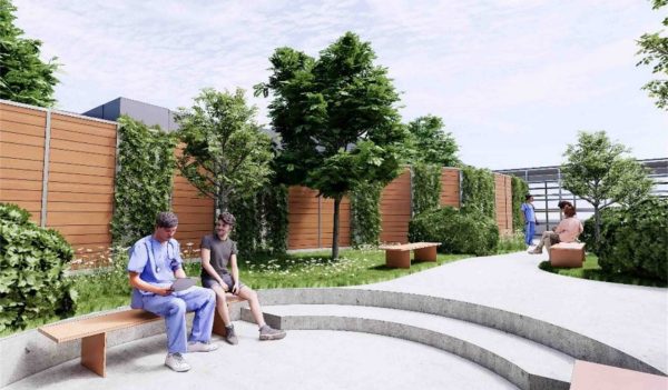 Exterior rendering of outdoor patient courtyard with benches and landscaping.