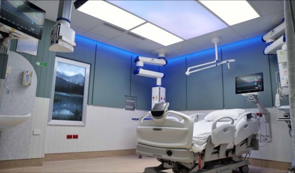 Interior of patient ICU room with hospital equipment and lighting to simulate the outdoors.