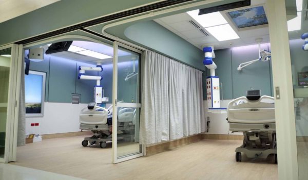 Interior view of two ICU patient rooms side by side with separator walls.