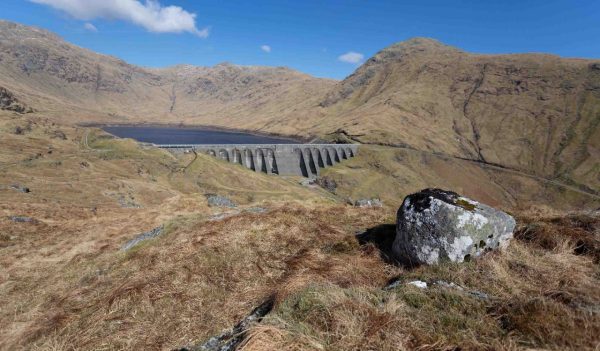 Landscape view of Cruachan Hydro Power Station surrounded by green hills 