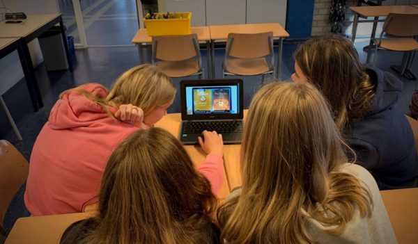 Laptop, classroom, students playing game, climate change