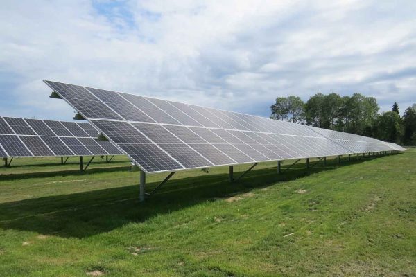 Solar panels in a field with a blue sky