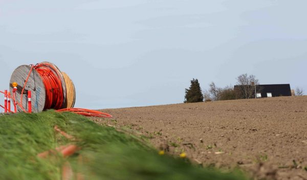 Large spool of fibre optic cable in a farmers field
