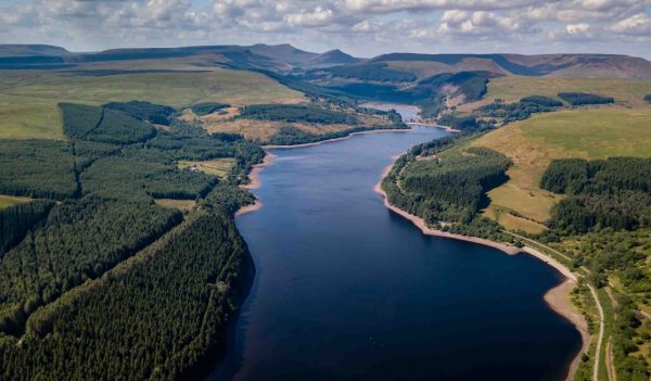Aerial drone view of low water levels in Pontsticill Reservoir, Brecon Beacons during a summer heatwave